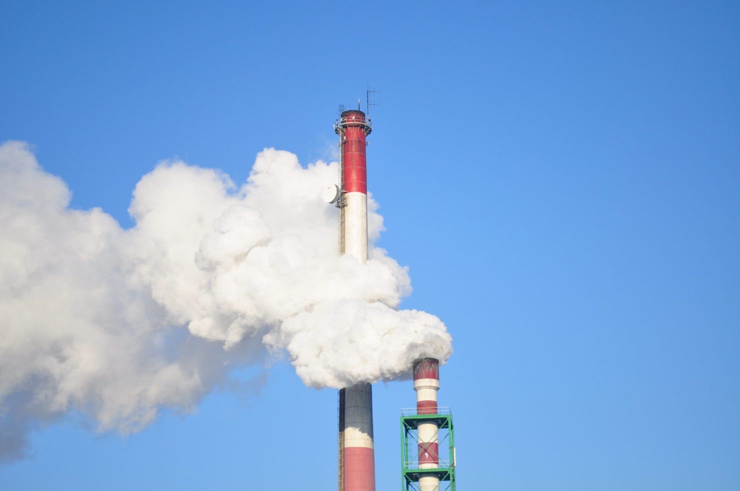 Industrial smokestacks emitting greenhouse gases