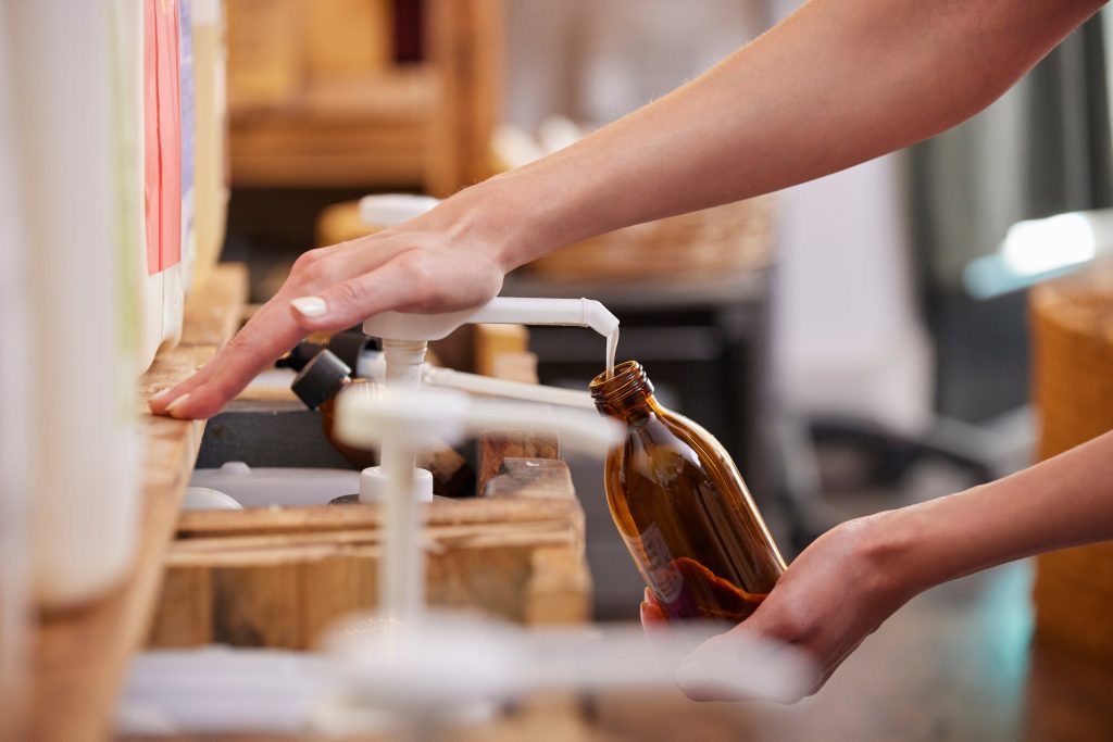 Refilling a reusable container at a refill station